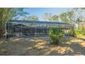 Screened-in pool with a brick patio and surrounding lush foliage, ideal for outdoor relaxation at 3864 Gocio Rd, Sarasota, FL 34235