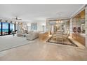 Expansive living room and dining area with ocean views, elegant furnishings, and neutral decor at 415 L Ambiance Dr # C404, Longboat Key, FL 34228