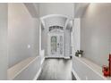 Bright foyer with high ceilings, wood-look floors, and arched entryways at 4360 85Th Avenue E Cir, Parrish, FL 34219