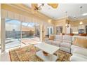 Spacious living room with pool view & comfy seating at 45 Grand Palms Blvd, Englewood, FL 34223