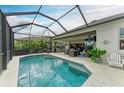 Screened pool and patio with outdoor seating and a built-in grill at 4512 Renwick Dr, Parrish, FL 34219