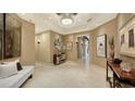 Bright and spacious entryway with large mirrors and modern furniture at 50 Central Ave # 17Phc, Sarasota, FL 34236