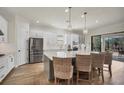 Modern kitchen with island, stainless steel appliances, and white cabinets at 5116 Tivoli Run, Bradenton, FL 34211