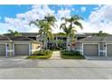 Condo building with attached garages and tropical landscaping at 5211 Mahogany Run Ave # 124, Sarasota, FL 34241