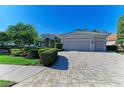 Two-story home with lush landscaping and paver driveway at 5224 88Th E St, Bradenton, FL 34211