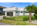 Modern house exterior with a landscaped lawn at 5351 Moeller Ave, Sarasota, FL 34233