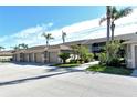 Exterior view of condo building with garages and landscaping at 5360 Hyland Hills Ave # 2622, Sarasota, FL 34241