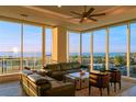 Luxury living room with floor-to-ceiling windows and water views at 540 N Tamiami Trl # 802, Sarasota, FL 34236