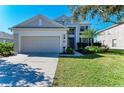 Two-story house with attached garage and landscaping at 5811 100Th E Ave, Parrish, FL 34219