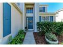 Front entrance with blue door, landscaping, and walkway at 5811 100Th E Ave, Parrish, FL 34219