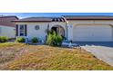 Charming single-story home featuring a well-maintained lawn and a two-car garage at 603 Chestnut Ln # 90, Englewood, FL 34223