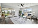 Living room with hardwood floors, glass coffee table, and comfy sofa at 609 10Th E Ave, Bradenton, FL 34208