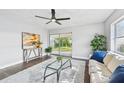 Living room with hardwood floors, glass coffee table, and comfy sofa at 609 10Th E Ave, Bradenton, FL 34208