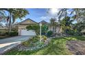 House exterior showcasing a well-maintained lawn and palm trees at 7349 Windemere Ln, University Park, FL 34201