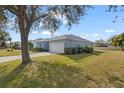 Side view of a one-story house with a garage and spacious backyard at 7432 39Th E Ct, Sarasota, FL 34243