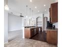Stylish kitchen with dark wood cabinets, modern appliances, breakfast bar and eat in space at 11715 Summer Springs Dr, Riverview, FL 33579