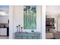 Console table with artwork, candles, and decorative bowl at 1228 Siesta Bayside Dr # 1228-C, Sarasota, FL 34242