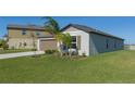 Single story home with brown garage door and lush green landscaping at 13608 Sunset Sapphire Ct, Parrish, FL 34219