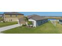 One-story home featuring a brown garage door and manicured lawn at 13608 Sunset Sapphire Ct, Parrish, FL 34219