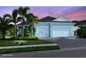 Two-story house with light blue exterior, white garage doors, and landscaping at 13619 Old Creek Ct, Parrish, FL 34219