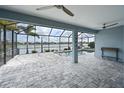 Covered patio overlooking a pool and lake at 13619 Old Creek Ct, Parrish, FL 34219