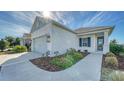 This lovely one-story house boasts a light gray exterior, a welcoming front porch, and neatly landscaped grounds at 14155 Campfire Ct, Parrish, FL 34219
