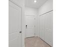 Interior entryway with white doors and tile flooring at 14824 Lyla Ter, Bradenton, FL 34211