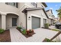 Front view of townhome with gray exterior, landscaping, and walkway at 14824 Lyla Ter, Bradenton, FL 34211