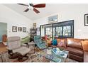 Bright living room with comfy seating and a view to the patio at 1512 Pelican Cove Rd # 239, Sarasota, FL 34231