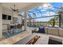 Outdoor kitchen, pool, and fire pit; overlooks a tranquil lake at 15608 Leven Links Pl, Lakewood Ranch, FL 34202