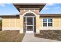 Front entrance with a screened porch and walkway at 1790 S Biscayne Dr, North Port, FL 34287