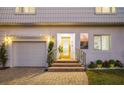 Inviting front entrance with a yellow door and brick walkway at 355 N Washington Dr, Sarasota, FL 34236