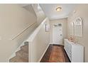Bright entryway with staircase, wood-look floors, and white console table at 509 Powder View Dr, Ruskin, FL 33570
