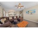 Spacious living room with L-shaped sectional sofa and large wall art at 509 Powder View Dr, Ruskin, FL 33570