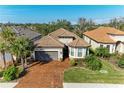 One-story house with a brown tile roof and a large driveway at 5406 Morey Farms Loop, Palmetto, FL 34221