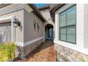 Front entry with stonework, blue door, and walkway at 5406 Morey Farms Loop, Palmetto, FL 34221