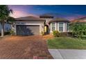 One-story house with brown tile roof, gray garage door, and well-manicured lawn at 5406 Morey Farms Loop, Palmetto, FL 34221