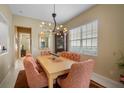 Elegant dining room with a formal table and chandelier at 5521 Bilbao Pl, Sarasota, FL 34238