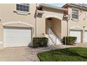 Charming townhome with a two-car garage, a well-kept lawn, and a welcoming entrance at 7254 Cedar Hollow Cir, Bradenton, FL 34203