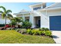 House exterior showcasing landscaping and a blue front door at 8066 Redonda Loop, Bradenton, FL 34202