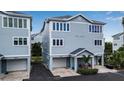 Two-story house with light gray siding and a two-car garage at 821 Evergreen Way, Longboat Key, FL 34228