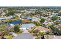 Aerial view of a residential neighborhood featuring houses, a pond, and a canal at 8348 9Th Avenue Nw Ter, Bradenton, FL 34209