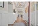 Bright and spacious entryway with wood floors and wainscoting at 8612 Sundance Loop, Sarasota, FL 34238