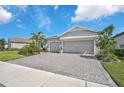 Two-car garage and paved driveway, nicely landscaped front yard at 8612 Sundance Loop, Sarasota, FL 34238