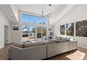 Spacious living room with large windows and a view of the water and outdoor deck at 140 N Casey Key Rd, Osprey, FL 34229