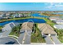 Aerial view of a single-story home showcasing the tile roof and the community lake at 15917 Clear Skies Pl, Lakewood Ranch, FL 34211