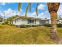 Front view of a single story home with palm trees at 1815 Vera Pl # 9, Sarasota, FL 34235