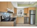Modern kitchen featuring stainless steel appliances and light wood cabinets at 1815 Vera Pl # 9, Sarasota, FL 34235