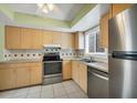 Bright kitchen with stainless steel appliances and light wood cabinets at 1815 Vera Pl # 9, Sarasota, FL 34235