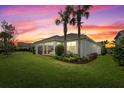 Spacious backyard with a screened patio and mature palm trees at 3314 Chestertown Loop, Bradenton, FL 34211